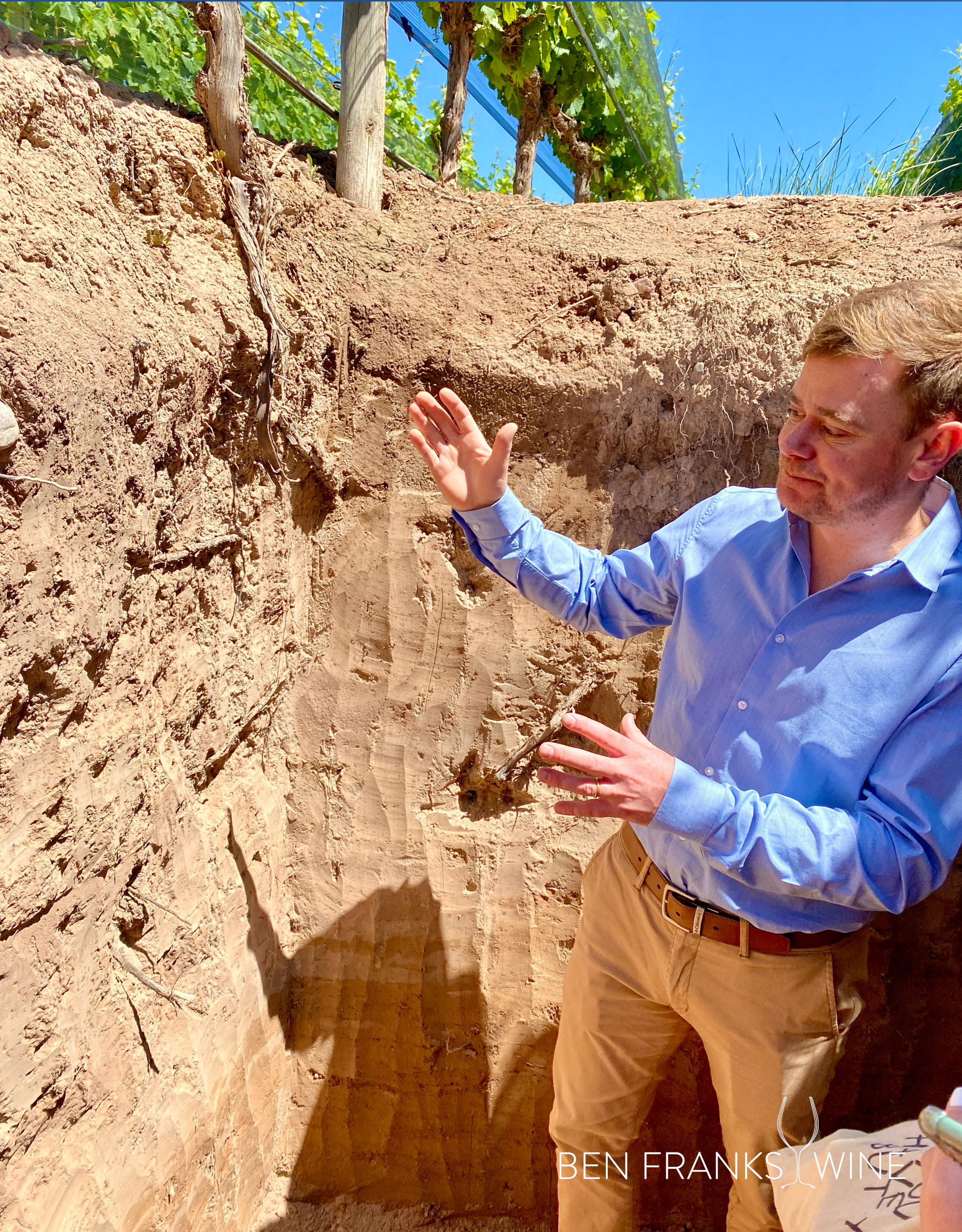 Mendoza Winemaker Tomas Hughes shows a sandy soil pit in his vineyard
